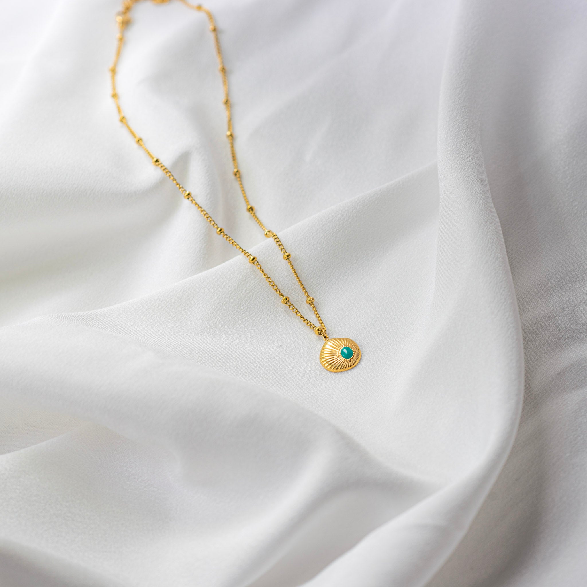 Zeyra Necklace | Turquoise Sunburst Gold Pendant — detail view — TJAURI jewelry